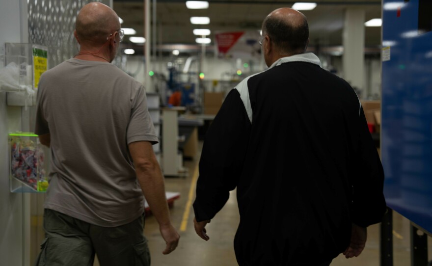 Roman (left) is a Ukrainian refugee who works at ComDel Innovation in Wahpeton, N.D. CEO Jim Albrecht (right) says the company has been working with a program called Uniting For Ukraine that provides a legal pathway for Ukrainians to come to the U.S. and work for up to two years.
