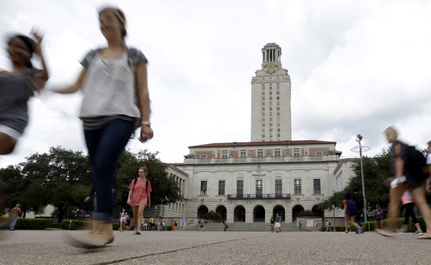 Students walk through the University of Texas, Austin, campus near the school's iconic tower.