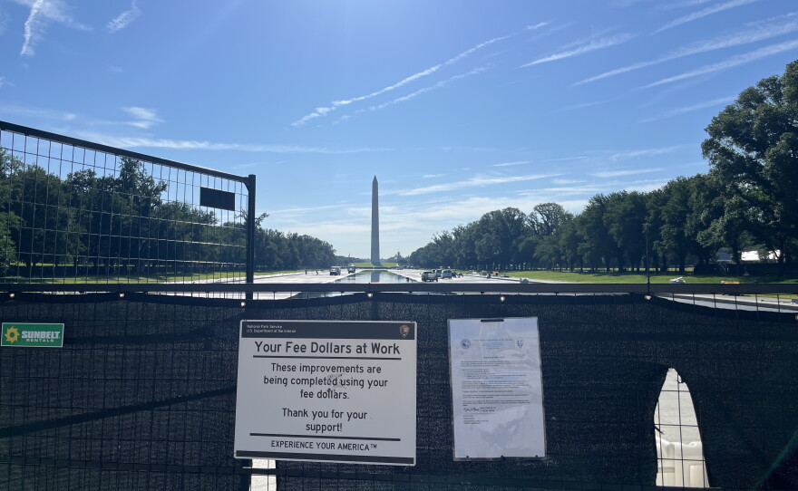 A sign outside the reflecting pool informs visitors that their national park fees helped fund the project.
