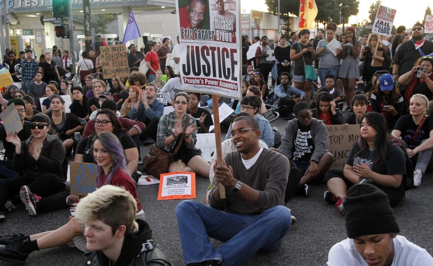 Protesters partake in a sit-in at an intersection Tuesday during a rally in Los Angeles.