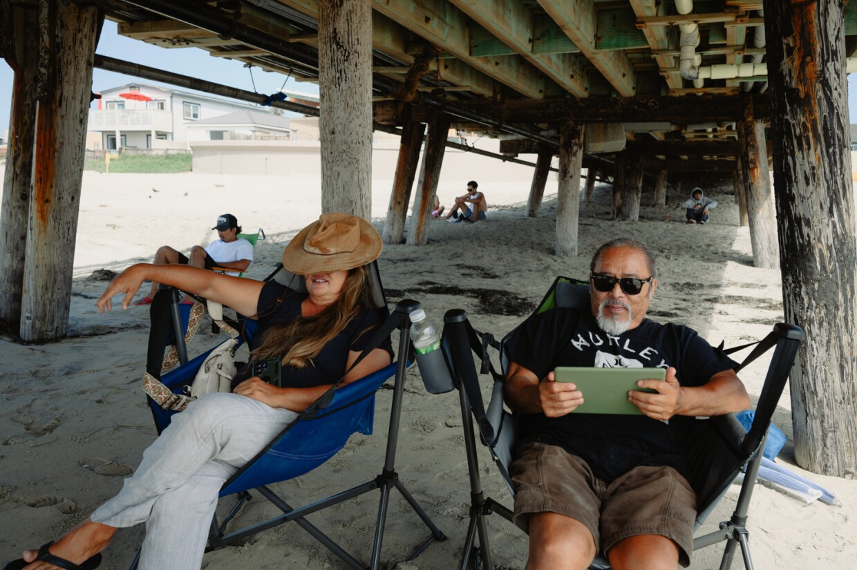 Katy, left, and Al, Imperial Beach residents of 17 years, relax in the shade below the IB Pier in Imperial Beach on September 3, 2024.