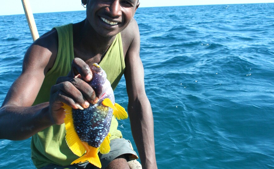 A fisherman in southwestern Madagascar holds up part of his haul.