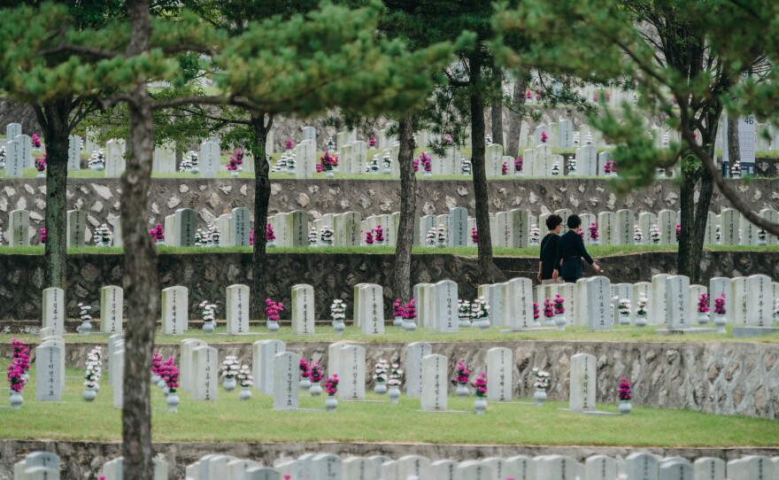 Visitors walk across a graveyard at the Seoul National Cemetery last week.