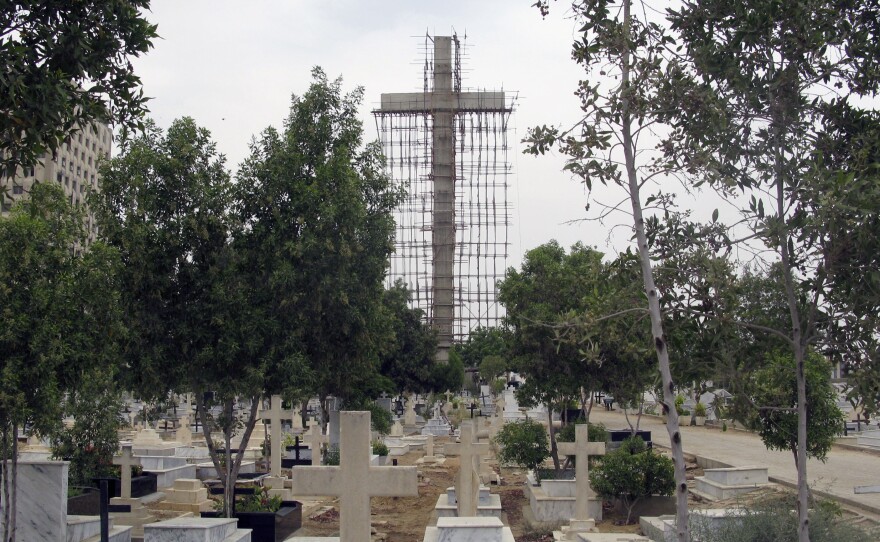 The cross is being built at the entrance to the main Christian cemetery in Karachi.