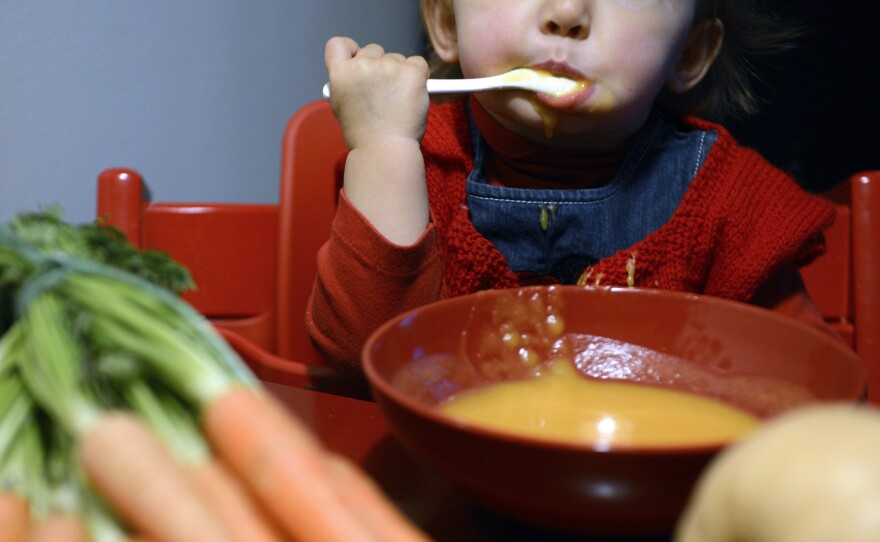 A child eats vegetable soup in Lyon, France. Many French parents expect their kids to eat sophisticated adult dishes at a young age.