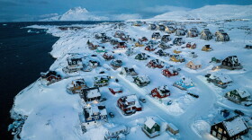 Houses covered in snow are seen on the coast of a sea inlet of Nuuk, Greenland, March 7, 2025.