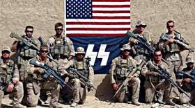 Marines pose with a flag bearing a symbol resembling the Nazi SS emblem in Afghanistan.