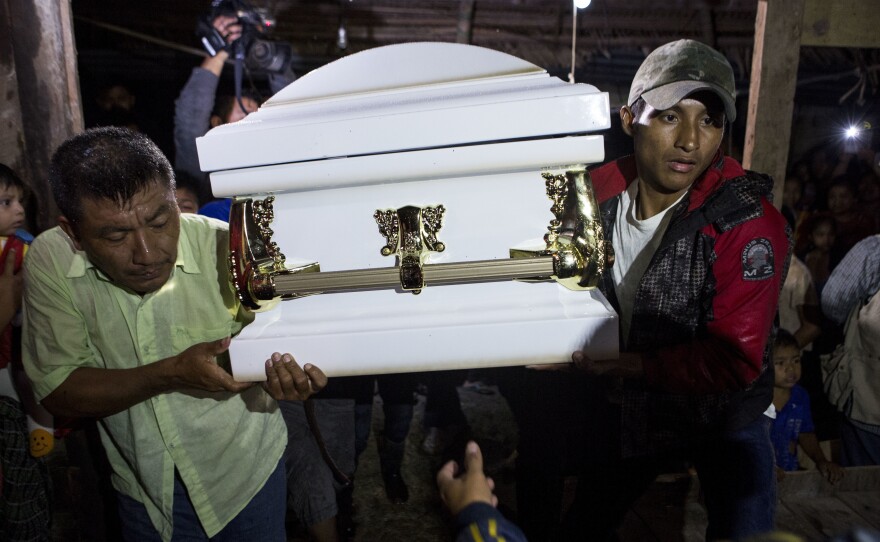 Neighbors carry the coffin that contains the body of Jakelin Caal Maquin into her grandparents' home in San Antonio Secortez, Guatemala. The 7-year-old girl died while in the custody of the U.S. Border Patrol.