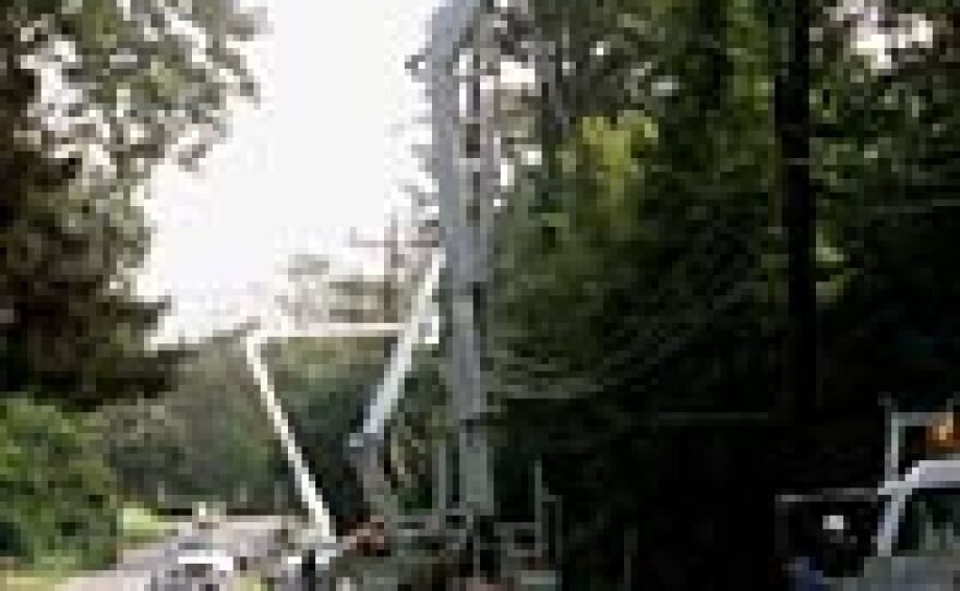 Power crews work to restore downed electrical lines in Silver Spring, Md., Sept. 20, 2003. Millions of people were left without power after Hurricane Isabel pushed through the Mid-Atlantic region.