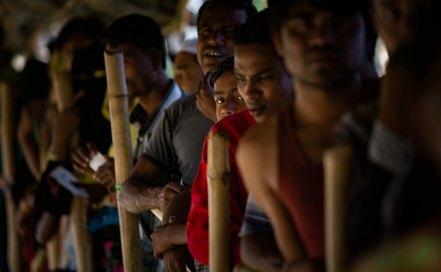Refugees wait for an aid distribution.