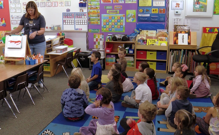A teacher works with students in a transitional kindergarten classroom in Alpine, Nov. 29, 2022.
