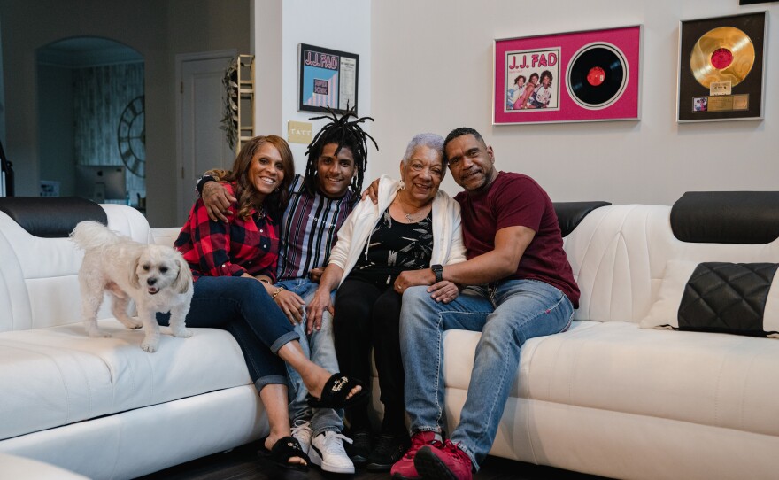 Michelle Ferrens, son Andre Lee, Patricia Villa, mother of Tyrone Ferrens, and Tyrone sit for a portrait in their house in Aberdeen, Md.