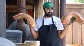 Zain Shafi prepares to put briskets in the smoker at Goldee's BBQ in Fort Worth, Texas.