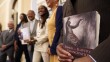 File photo of Dr. Amos C. Brown, Jr., vice chair for the California Reparations Task Force, right, holds a copy of the book Songs of Slavery and Emancipation, as he and other members of the task force pose for photos at the Capitol in Sacramento, Calif., on June 16, 2022.