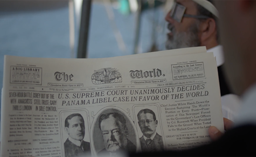 Scene from the “Joseph Pulitzer” film showing the headlines in the newspaper that reads “U.S. Supreme Court Unanimously Decides Panama Libel Case In Favor Of The World.”