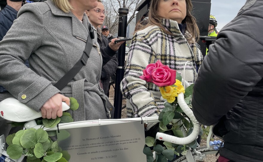 Jaime Bolognone prepare to take a ghost bike honoring her late fiancé, Gerardo Marciales, out into the intersection where he was recently killed.