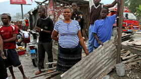 Louisanna  Dema has lived along the median of Route Nationale 2, just south of  Port-au-Prince, for just over a year.  She and her family are finally moving out  of their sheet metal shack and into a "transitional shelter" provided by a  relief agency.