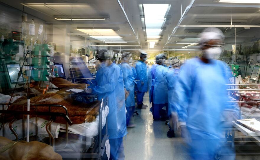 Health workers care for COVID-19 patients in the emergency room of a hospital in Porto Alegre, Brazil, on March 11.