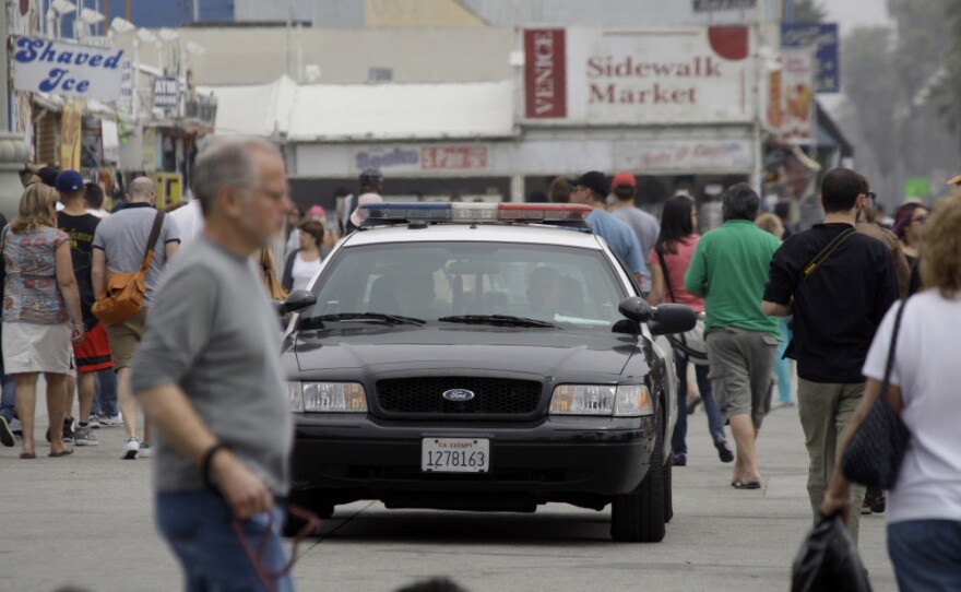 Los Angeles police patrol Ocean Front Walk in Venice Beach, a popular tourist destination, earlier this month. On April 16, a man was shot in an incident that police officials suspect was a flash mob organized on Twitter.