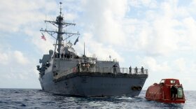In this photo provided by the U.S. Navy, the guided-missile destroyer USS Bainbridge tows the lifeboat from the Maersk Alabama to be processed for evidence after the successful rescue of Capt. Robert Phillips April 13, 2009 in the Indian Ocean. 