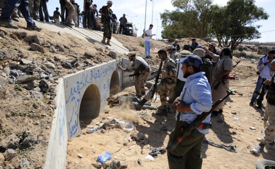 <p>Libyan Transitional National Council fighters said Moammar Gadhafi was captured Thursday in this graffitti-filled culvert in Sirte.</p>