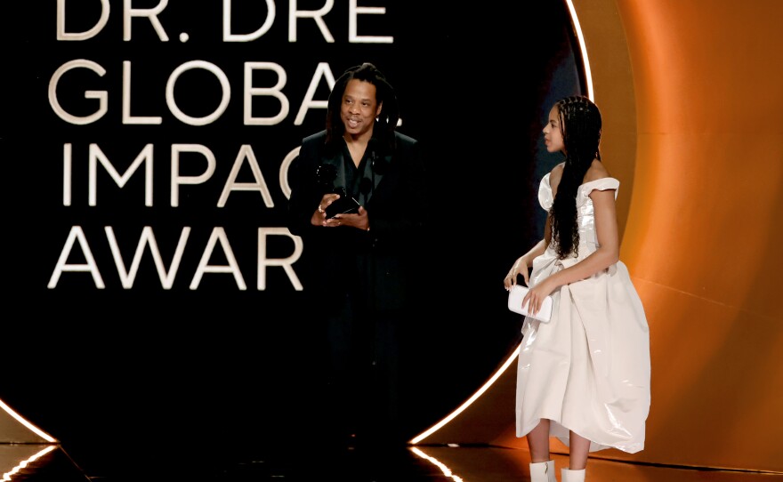 Jay-Z (left), accompanied by his daughter, Blue Ivy Carter, accepts the honorary Dr. Dre global impact award at the 2024 Grammys,