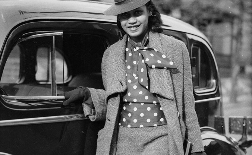 Barbara Jones posed next to car on Mulford Street, Homewood, Pittsburgh, Pa, c. 1937.