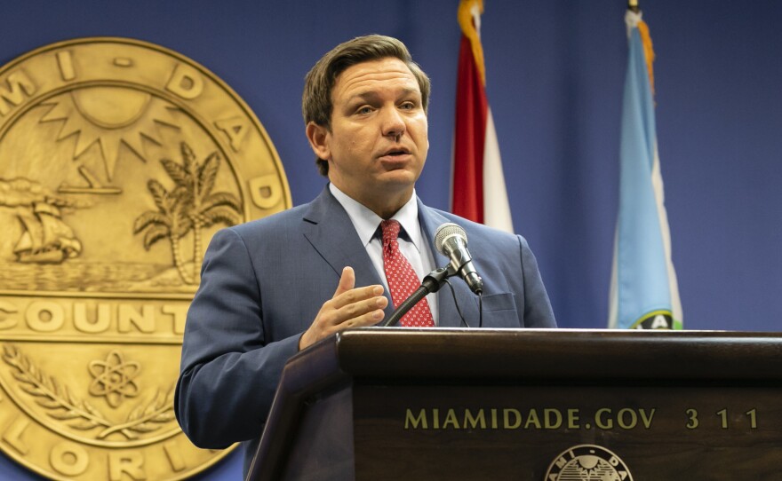 Florida Gov. Ron DeSantis, seen here in June, said this week that the state's troubled unemployment portal was designed to discourage people applying for benefits. The portal launched in 2013, under then-Gov. Rick Scott.