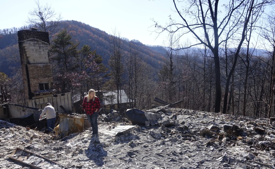 Tammy Sherrod and her husband, Scott, examine the remains of their home in the Roaring Fork neighborhood of Gatlinburg, Tenn., on Friday. Residents were getting their first look at what remains of their homes and businesses after a wildfire tore through the resort community.