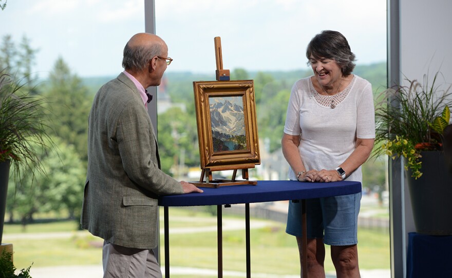 Michael B. Grogan (left) appraises an Edgar Payne landscape oil, ca. 1920, in Shelburne, Vt.