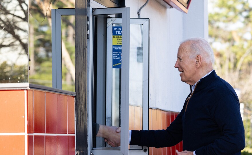 President Biden shakes hands through a take-out window after ordering food from Cook Out in Raleigh, N.C. on Jan. 18, 2024.