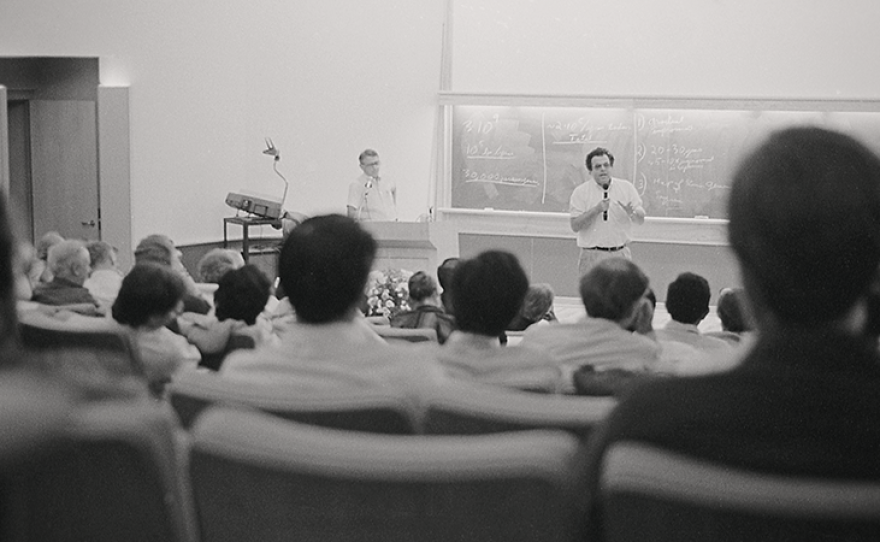 David Botstein, the father of gene mapping, and Paul Berg, the father of recombinant DNA, address an audience at Cold Spring Harbor Laboratory at a 1986 symposium on sequencing human DNA.