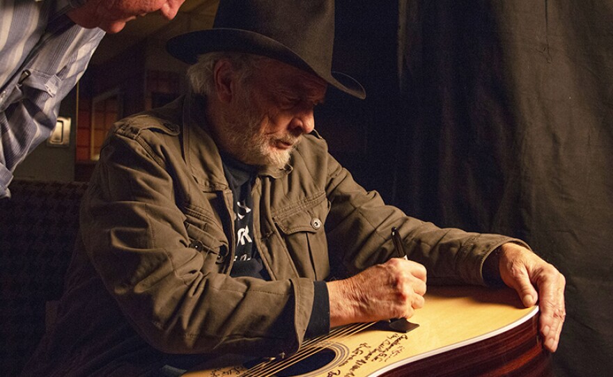 Merle Haggard signs Martin D-28 guitar. Haggard is among the 76 of the 101 country music artists interviewed for the series who signed two Martin D-28 guitars. He was born in 1937 during the Great Depression.