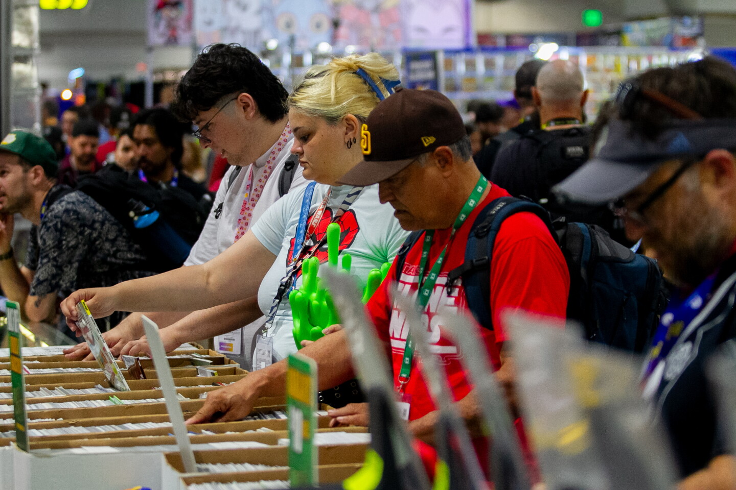 Comic-Con attendees look through stacked of comics for sale at Comic-Con, April 23, 2026.