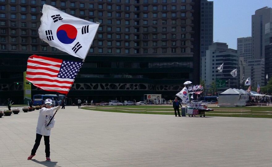 A demonstrator waves U.S. and South Korean flags together, at a pro-U.S. rally in front of Seoul's City Hall on Saturday.