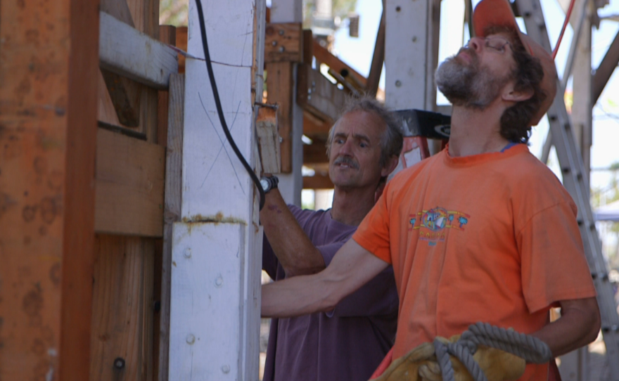 Volunteers help remove scaffolding from the Sn Salvador at Spanish Landing Park, April 10, 2015.