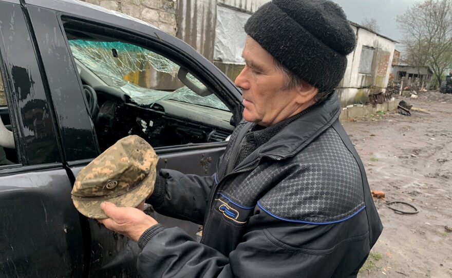 Anatolii Kulibaba, 70, holds his son Oleksandr's hat near his destroyed truck last month in Bilka, Ukraine. His son was killed by Russian forces early in the war.