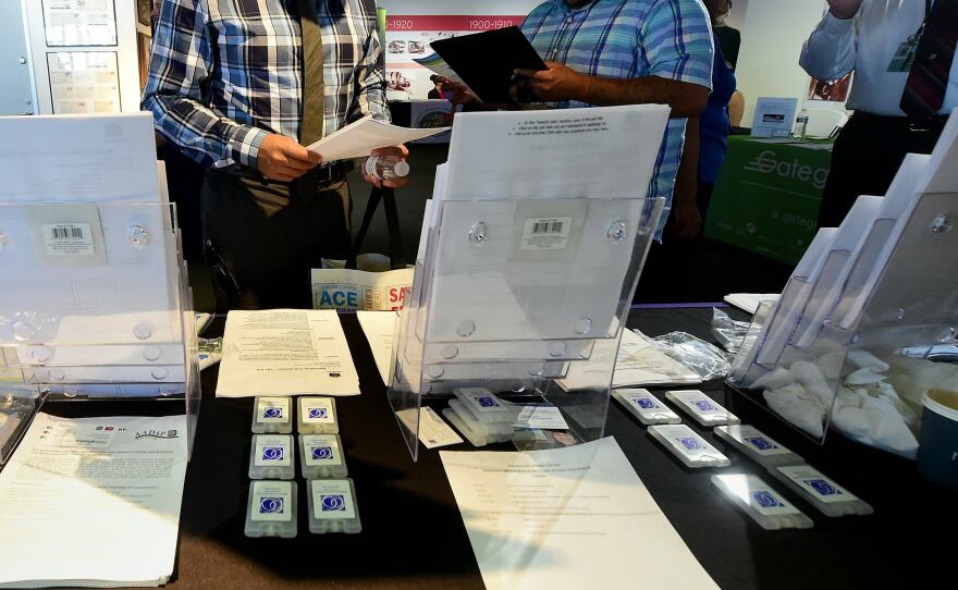 Job seekers look over forms while attending the first Los Angeles International Airport Job Fair for Veterans in Los Angeles on Sept. 14.
