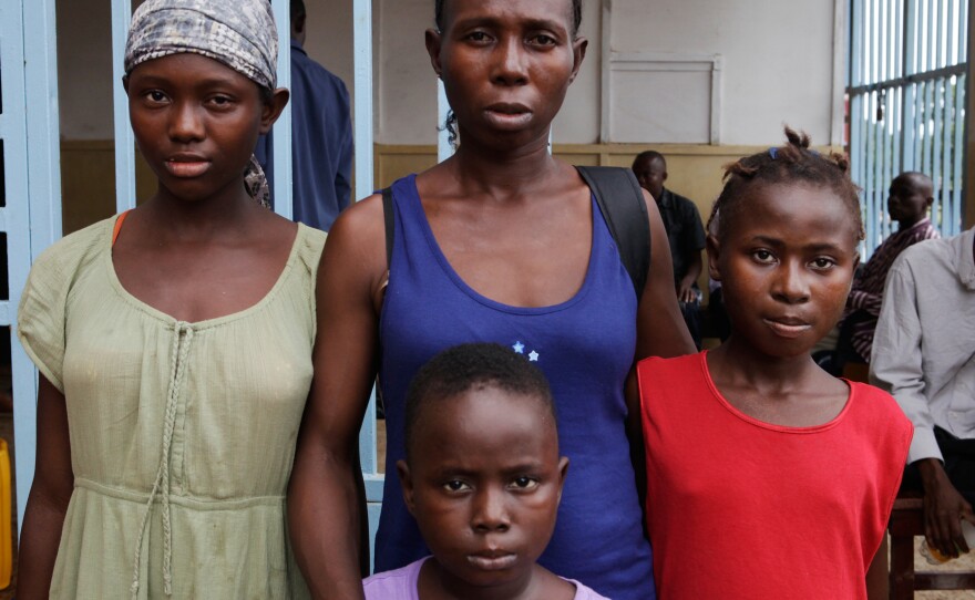 Meriatu Kamara, 35, lost her husband and two children to Ebola. But she and three of her children survived: (from left) Sallaymatu, Abubakar, Aminatu. They've lived in the survivors' ward for two months. They're from Makeni, a city 130 miles away and haven't yet been able to make their way home.