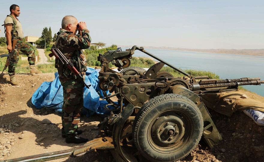 Kurdish forces, known as the pesh merga, stand guard near the Mosul Dam on Aug. 17. U.S. airstrikes against the Islamic State allowed the pesh merga to move in and take the area around the dam recently.