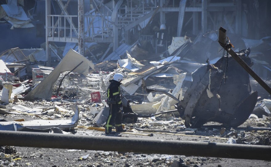 An Ukrainian firefighter works near a destroyed building on the outskirts of Odesa, Ukraine, on Tuesday. The Ukrainian military said Russian forces fired seven missiles a day earlier from the air at the crucial Black Sea port of Odesa, hitting a shopping center and a warehouse.