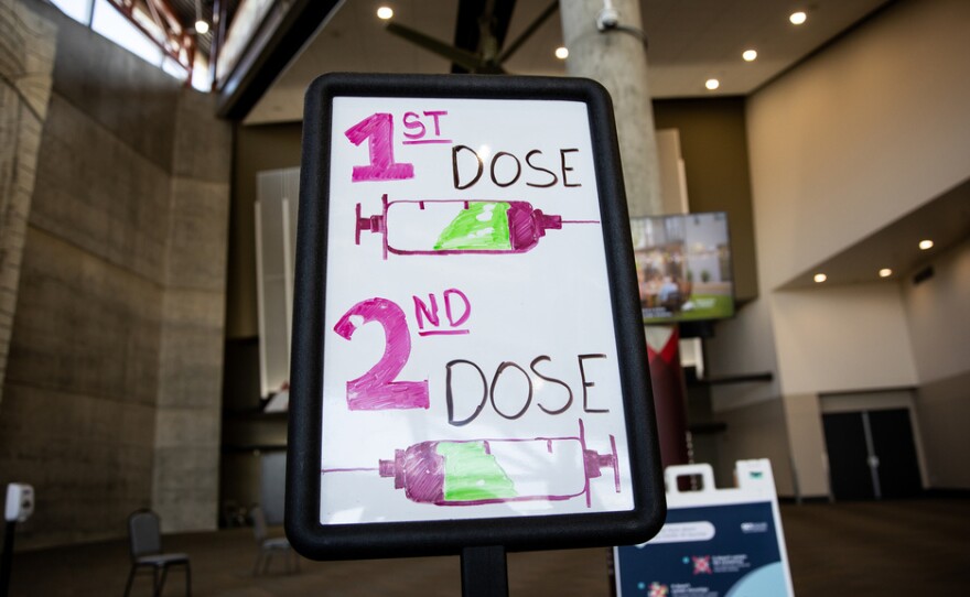 Signs direct people arriving to get COVID-19 vaccines at the Mountain America Expo Center in Sandy, Utah, on April 22.