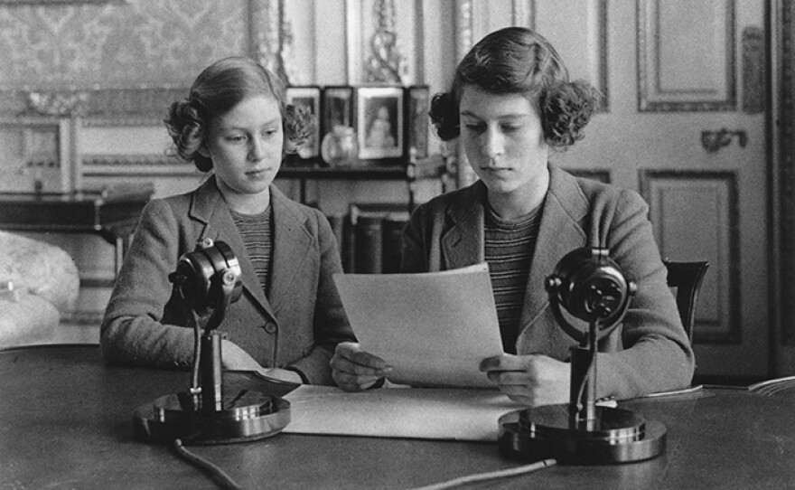 Princess Elizabeth and her sister Princess Margaret at the microphone for Elizabeth's first broadcast. She is the future Queen Elizabeth II of England. 1940