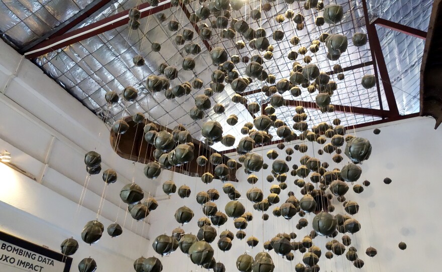 An exhibit of "bombies," or cluster submunitions, at the visitor center for the nonprofit COPE. An estimated 30 percent of bombs dropped on Laos by U.S. forces during the Vietnam War failed to explode, so they continue to cause casualties today.