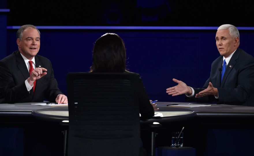 Tim Kaine (left) and Mike Pence take questions from moderator Elaine Quijano during the vice presidential debate at Longwood University in Farmville, Va., on Tuesday.