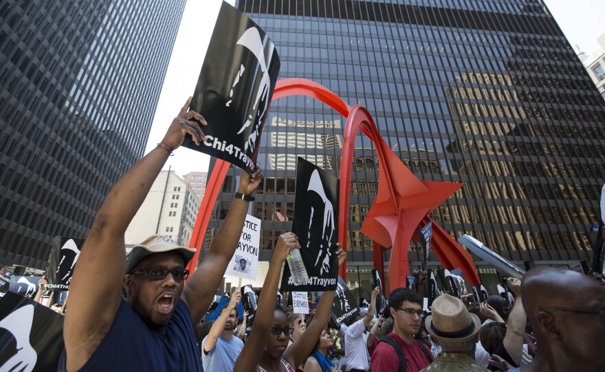 A man holds up a sign at the "Justice for Trayvon" rally in downtown Chicago on Saturday.