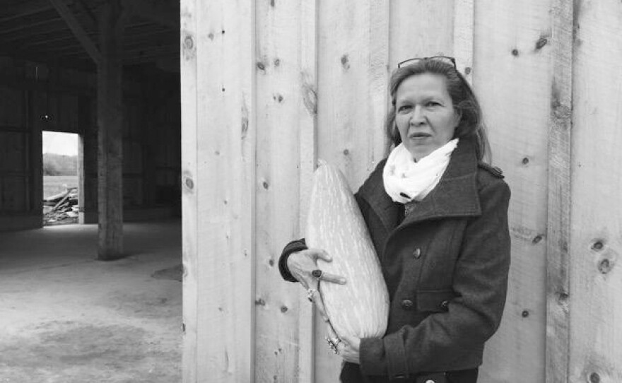 Punkin Shananaquet, a member of the Gun Lake tribe, holds a Gete Kosman squash at the Gteganes Farm in west Michigan. This squash, which until recently was thought to be extinct, is one of dozens of traditional crops being cultivated as part of a revival of foods native to the Great Lakes region.