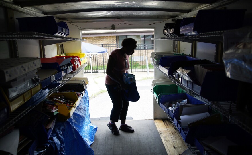 A Dayspring Head Start employee chooses school supplies in the back of the Supply Mobile box truck.