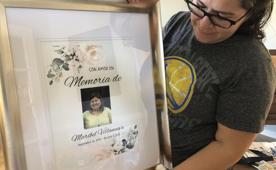 Susana Villanueva holds a photo of her sister Maribel at her home in Oakland on Aug. 3, 2021.