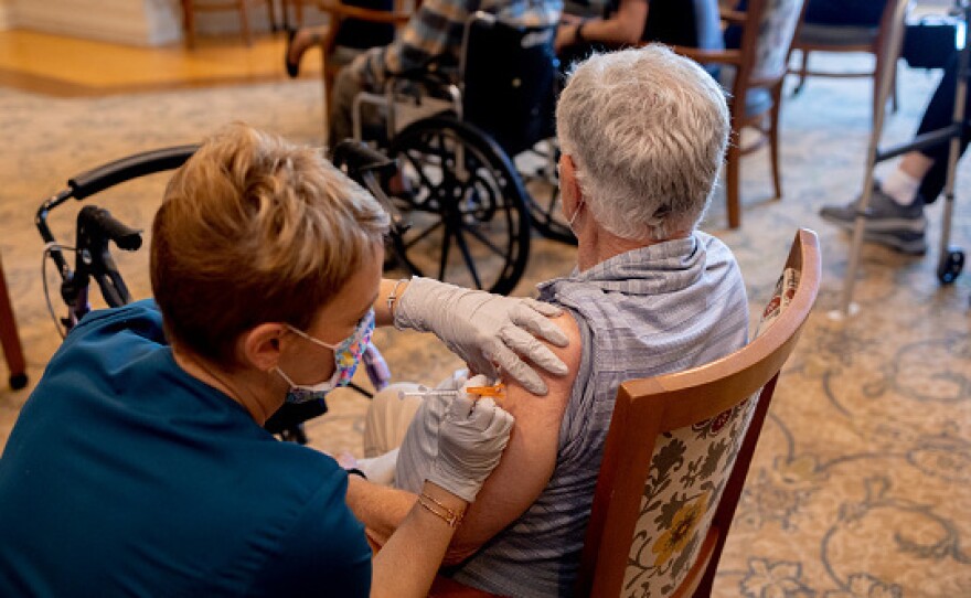 A health care worker administered a third dose of the Pfizer-BioNTech Covid-19 vaccine at a senior living facility in Worcester, Penn., in August.